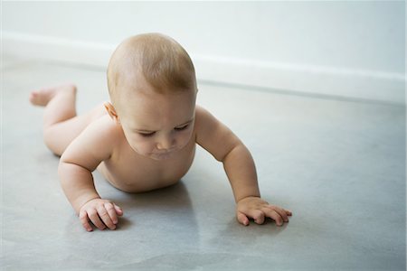 Baby lying on floor, full length Stock Photo - Premium Royalty-Free, Code: 695-03376603