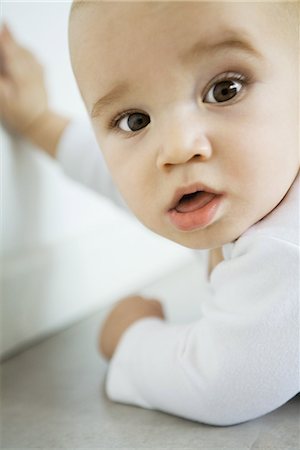 Baby turning head to look at camera, close-up Stock Photo - Premium Royalty-Free, Code: 695-03376629