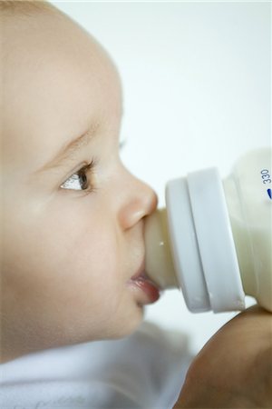 Baby drinking from bottle, extreme close-up, side view Stock Photo - Premium Royalty-Free, Code: 695-03376631