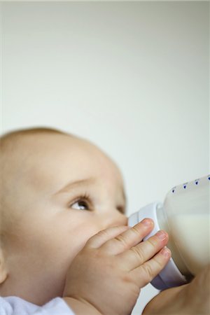Baby drinking from bottle Stock Photo - Premium Royalty-Free, Code: 695-03376633