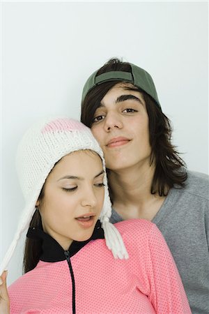 simsearch:695-03376692,k - Portrait of young couple, both wearing hats, male smiling at camera, female looking away Stock Photo - Premium Royalty-Free, Code: 695-03376702