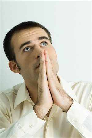 religion sign - Man praying, looking up Stock Photo - Premium Royalty-Free, Code: 695-03376738
