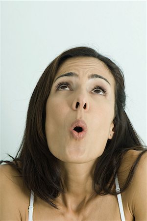 Woman looking up, surprised, portrait Stock Photo - Premium Royalty-Free, Code: 695-03376739