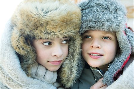 furry preteen - Sister and brother wearing fur caps, smiling, looking away, portrait Stock Photo - Premium Royalty-Free, Code: 695-03376850