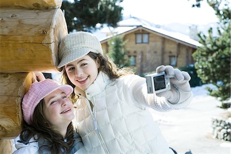 simsearch:695-03389357,k - Teenage girl holding up digital camera, photographing self with friend, both smiling Stock Photo - Premium Royalty-Free, Code: 695-03376873