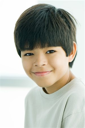 preteen boy happy white background - Boy smiling at camera, portrait Stock Photo - Premium Royalty-Free, Code: 695-03376916