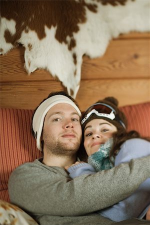 female cow sitting - Young couple reclining on couch, smiling at camera Stock Photo - Premium Royalty-Free, Code: 695-03377329