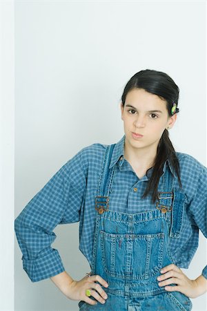 dissatisfied - Teenage girl with hands on hips, smirking at camera Stock Photo - Premium Royalty-Free, Code: 695-03377348