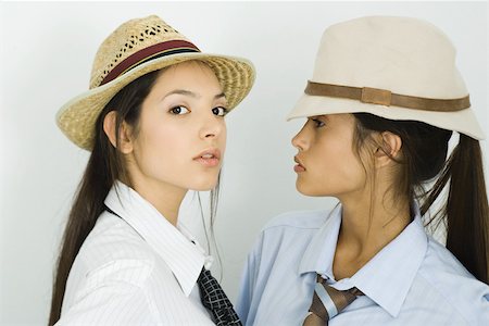 simsearch:400-03929864,k - Two young female friends wearing hats and ties, one looking at camera Stock Photo - Premium Royalty-Free, Code: 695-03377374