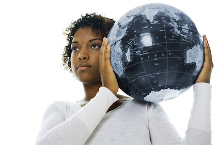 Young woman carrying globe on shoulder, looking away Stock Photo - Premium Royalty-Free, Code: 695-03377803