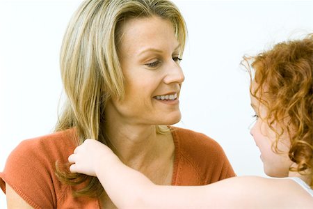 simsearch:695-03375963,k - Girl touching her mother's hair, both smiling, close-up Stock Photo - Premium Royalty-Free, Code: 695-03377859