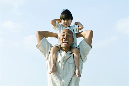 simsearch:632-01148477,k - Man carrying son on shoulders, both smiling at camera Stock Photo - Premium Royalty-Free, Code: 695-03377864