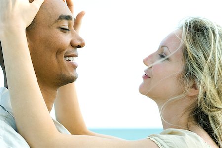Couple face to face with eyes closed, woman touching man's head Stock Photo - Premium Royalty-Free, Code: 695-03377872