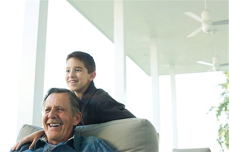simsearch:632-02344964,k - Grandfather and grandson together on porch, both smiling at looking away Stock Photo - Premium Royalty-Free, Code: 695-03378008