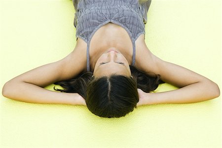 simsearch:695-03378072,k - Teenage girl lying on back with hands under head, eyes closed, high angle view Stock Photo - Premium Royalty-Free, Code: 695-03378071