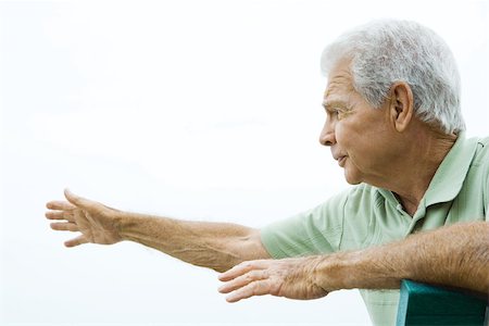 reaching senior - Senior man sitting with arms outstretched, looking away, side view Stock Photo - Premium Royalty-Free, Code: 695-03378088