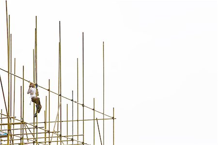 simsearch:700-07698543,k - Worker on scaffolding, low angle view Stock Photo - Premium Royalty-Free, Code: 695-03378148