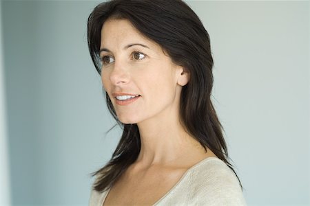 Brunette woman, smiling, looking away, head and shoulders, portrait Stock Photo - Premium Royalty-Free, Code: 695-03378191