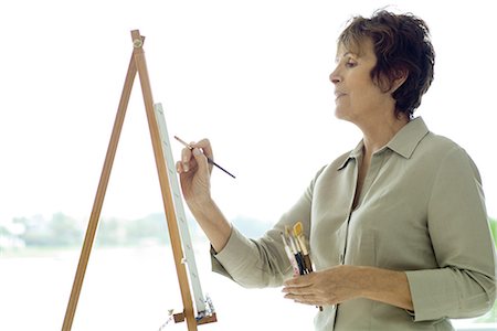 painter - Woman painting on canvas, side view, close-up Foto de stock - Sin royalties Premium, Código: 695-03378314