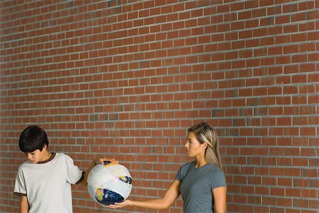 Woman and boy holding globe wrapped in bandages, woman looking at boy, boy looking down Stock Photo - Premium Royalty-Free, Code: 695-03378333