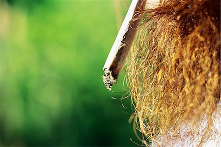 Man smoking hand-rolled cigarette, extreme close-up Stock Photo - Premium Royalty-Free, Code: 695-03378377