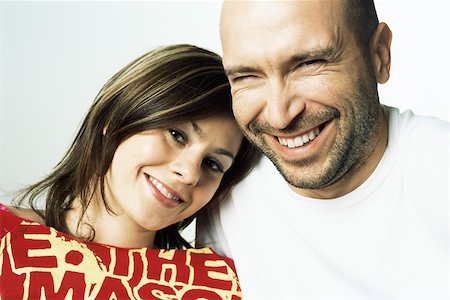 Woman leaning her head on man's shoulder, both smiling at camera Stock Photo - Premium Royalty-Free, Code: 695-03378397