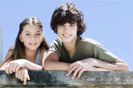 Two young friends standing side by side, smiling at camera, portrait Stock Photo - Premium Royalty-Free, Code: 695-03378688