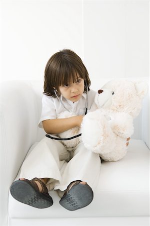 Little boy playing doctor with stuffed toy, using stethoscope Stock Photo - Premium Royalty-Free, Code: 695-03378812