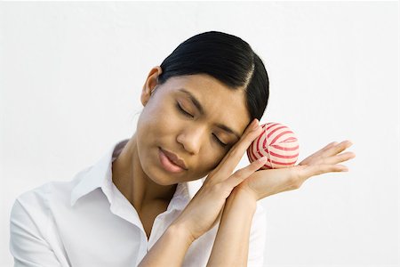 simsearch:695-03390134,k - Young woman resting head on hands, holding ball, eyes closed Stock Photo - Premium Royalty-Free, Code: 695-03378893