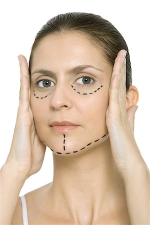 simsearch:695-03380175,k - Woman with plastic surgery markings on face, holding face in hands, looking at camera Stock Photo - Premium Royalty-Free, Code: 695-03379025
