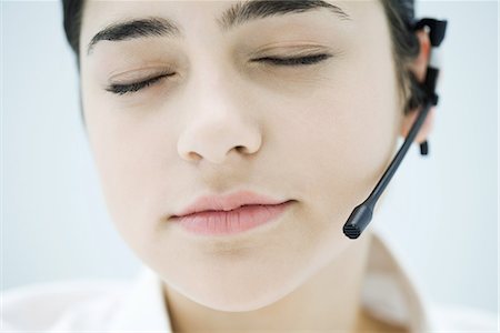simsearch:695-03390134,k - Woman wearing headset, closing eyes, close-up of face Stock Photo - Premium Royalty-Free, Code: 695-03379106