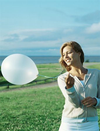 simsearch:633-01992711,k - Young woman holding balloon Stock Photo - Premium Royalty-Free, Code: 695-03379269