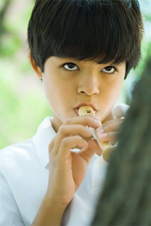 recorder - Boy playing recorder, close-up Stock Photo - Premium Royalty-Free, Code: 695-03379321