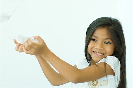 Girl holding fake butterflies Stock Photo - Premium Royalty-Free, Code: 695-03379347