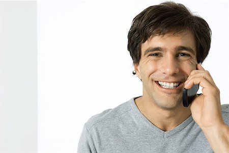 simsearch:695-03380514,k - Man using cell phone, smiling at camera Stock Photo - Premium Royalty-Free, Code: 695-03379379