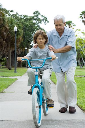 simsearch:633-03444679,k - Grandfather teaching boy to ride bicycle, full length Foto de stock - Sin royalties Premium, Código: 695-03379460