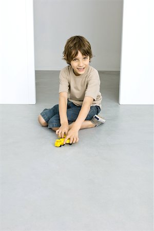 Boy playing with toy trucks Stock Photo - Premium Royalty-Free, Code: 695-03379502