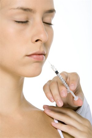 Woman receiving botox injection, eyes closed, close-up Stock Photo - Premium Royalty-Free, Code: 695-03379534