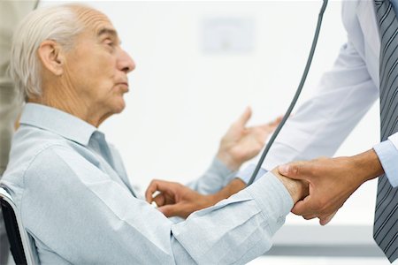 simsearch:695-05771249,k - Doctor measuring senior man's pulse, cropped view Stock Photo - Premium Royalty-Free, Code: 695-03379560