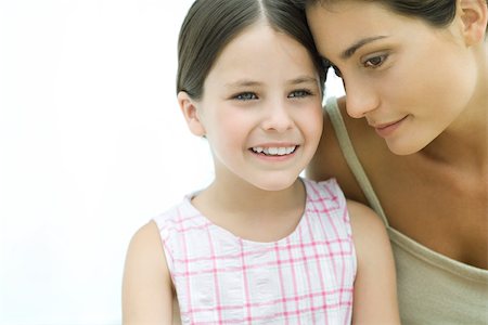 simsearch:633-02066083,k - Mother leaning her head against daughter,  both smiling, close-up Stock Photo - Premium Royalty-Free, Code: 695-03379620