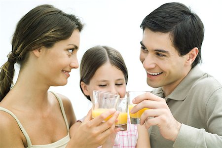 simsearch:614-06311930,k - Family making a toast with orange juice, all smiling Stock Photo - Premium Royalty-Free, Code: 695-03379622