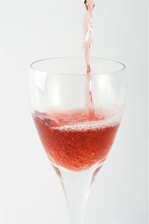 rose wine white background - Rose wine pouring into glass, close-up Stock Photo - Premium Royalty-Free, Code: 695-03379636