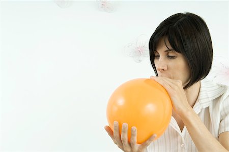 simsearch:695-03380144,k - Woman inflating balloon Stock Photo - Premium Royalty-Free, Code: 695-03379666