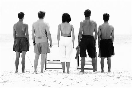 family outdoors black and white - Family standing side by side at the beach, rear view Stock Photo - Premium Royalty-Free, Code: 695-03379773