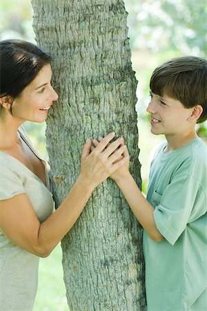 female tree huggers - Mother and son embracing tree, smiling at each other Stock Photo - Premium Royalty-Free, Code: 695-03379887