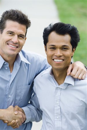 simsearch:695-03374588,k - Two businessmen shaking hands, both smiling at camera, high angle view Stock Photo - Premium Royalty-Free, Code: 695-03379915