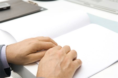 Man reading braille, cropped view of hands Stock Photo - Premium Royalty-Free, Code: 695-03379937