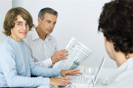 simsearch:695-03379156,k - Teen boy at table with father, using laptop computer, man reading newspaper Stock Photo - Premium Royalty-Free, Code: 695-03379931