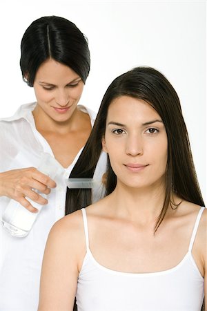 fixing hair - Woman having her hair styled, smiling at camera Stock Photo - Premium Royalty-Free, Code: 695-03379977