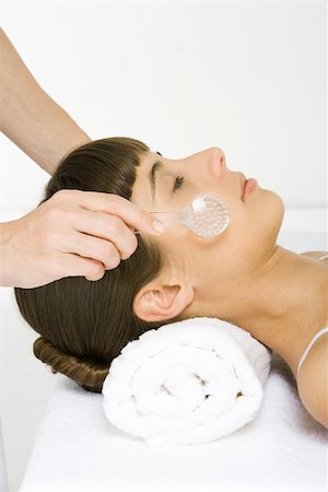 Woman having face exfoliated, eyes closed, side view Stock Photo - Premium Royalty-Free, Code: 695-03379990